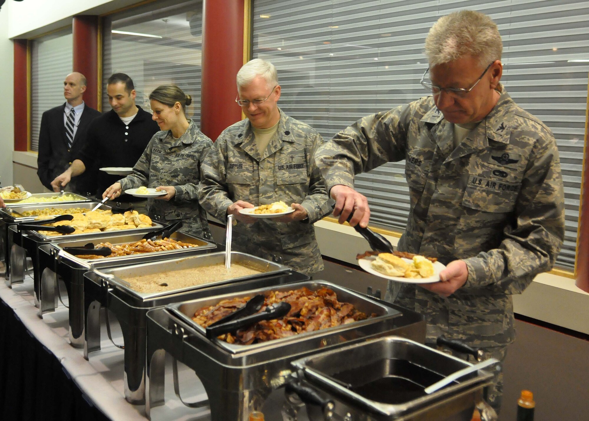 Members of the Joint Base Lewis-McChord community, including active duty Airmen and Reservists, get food before the start of the annual National Prayer Breakfast Feb. 1, 2012, at Joint Base Lewis-McChord, Wash. (U.S. Air Force photo/Airman 1st Class Leah Young)