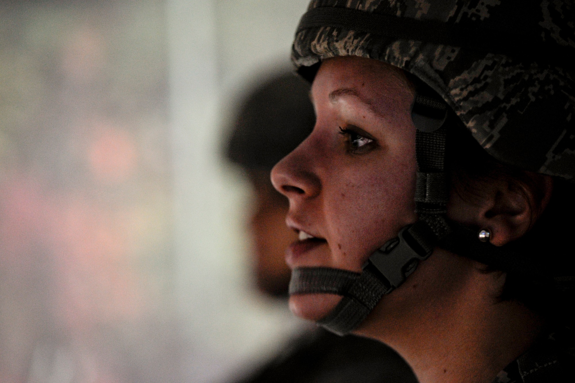 VANDENBERG AIR FORCE BASE, Calif. - Airman 1st Class Molly Shortt, a 30th Security Forces Squadron member, talks down an aggressive suspect during a scenario in the firearms training simulator at the Combat Arms Training Complex (Building 21308) here Friday, Jan. 27, 2012. The new simulator provides a virtual training environment for Vandenberg members to practice real-world combat tactics and scenarios based on Air Force qualification courses. (U.S. Air Force/Staff Sgt. Levi Riendeau)

