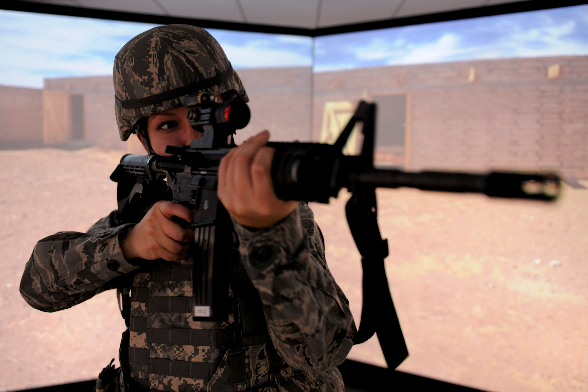 VANDENBERG AIR FORCE BASE, Calif. - Airman 1st Class Molly Shortt, a 30th Security Forces Squadron member, runs through a combat scenario in the firearms training simulator at the Combat Arms Training Complex (Building 21308) here Friday, Jan. 27, 2012. The new simulator provides a virtual training environment for Vandenberg members to practice real-world combat tactics and scenarios based on Air Force qualification courses. (U.S. Air Force/Staff Sgt. Levi Riendeau)
