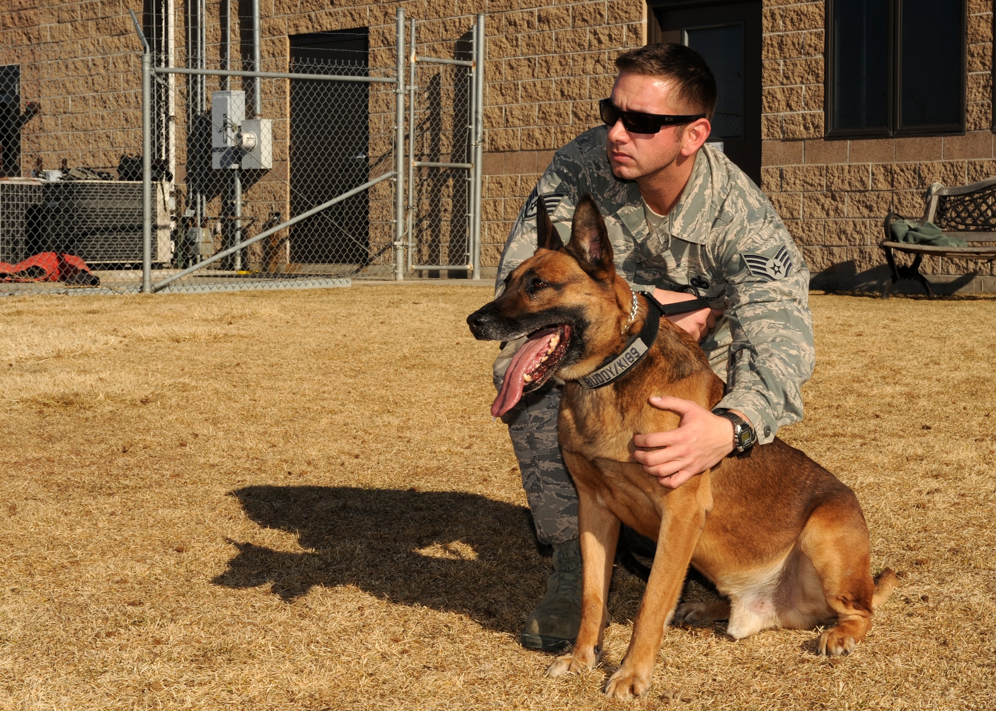 BUCKLEY AIR FORCE BASE, Colo. -- Staff Sgt. Michael Clark, 460th Security Forces military working dog handler, puts his partner, Buddy, at ease Jan 10, 2012. K-9 handlers are a devoted unit that spend much of their time with their K-9 partners training and preparing for deployments. (U.S. Air Force photo by Senior Airman Marcy Glass)
