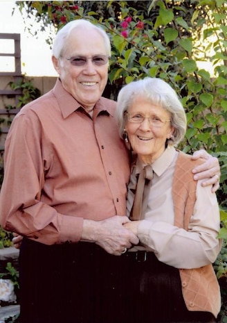 Jim Mauck, 99th Aerospace Medicine Squadron Optometry Clinic dispense clerk, stands with his wife Betty outside their home in Las Vegas, Nev.  Mauck was recently recognized as the Installation Volunteer of the Month for November 2011 for his outstanding work in the optometry clinic.  Mauck has been volunteering at the clinic for 17 years. (Courtesy photo)