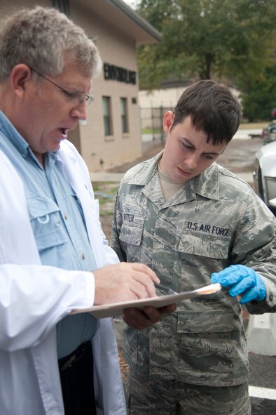 U.S. Air Force Senior Airman Travis Ritter and Richard Gilbride, both 23rd Civil Engineer Squadron pest management technicians, monitor how much chemical should be applied per square foot at Moody Air Force Base Ga., Jan. 22, 2012. Gilbride and Ritter must calculate how much of the chemical is needed in order to get the right amount to cover an area. (U.S. Air Force Photo by Airmen 1st Class Paul Francis/Released)
