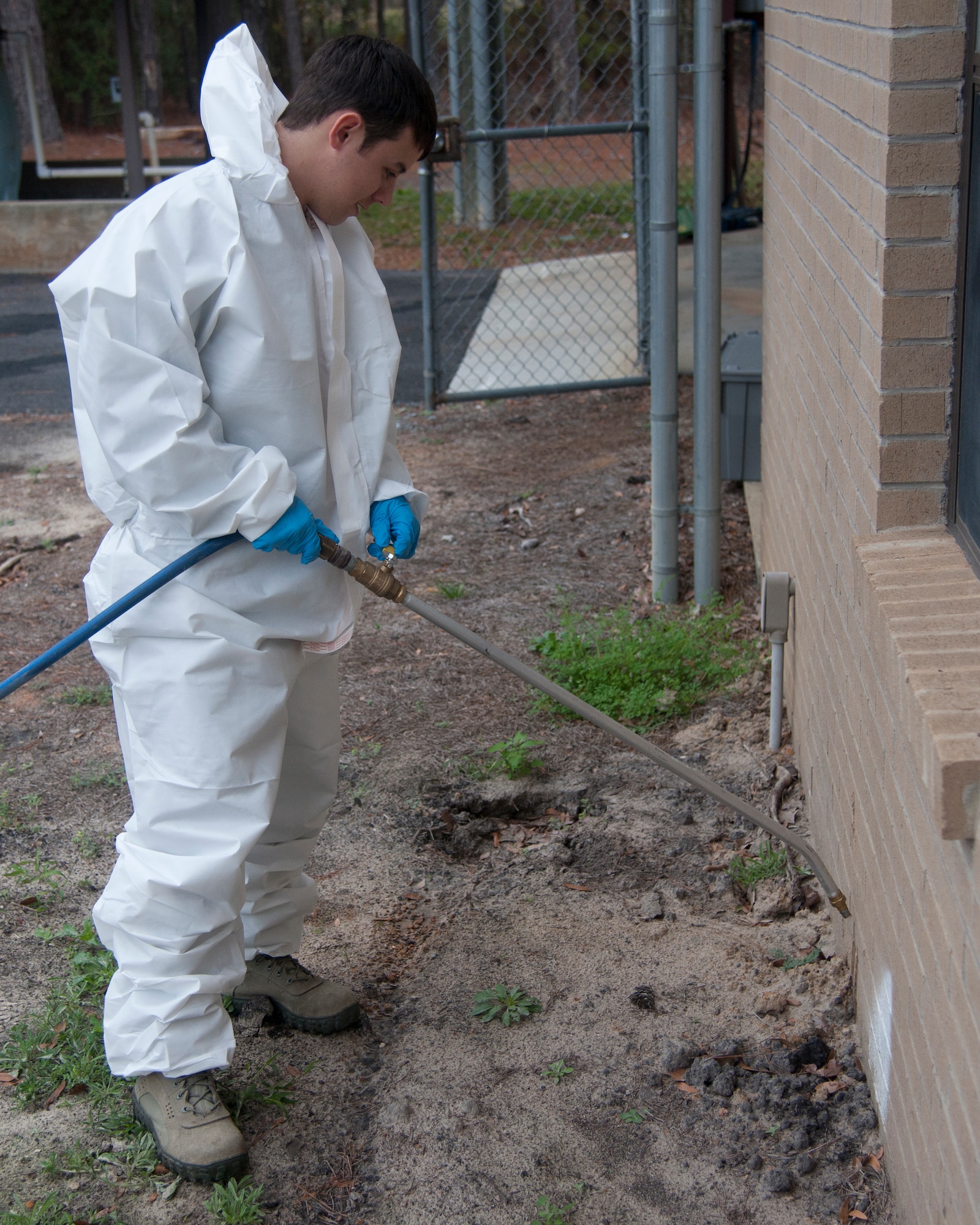 U.S. Air Force Senior Airman Travis Ritter, 23d Civil Engineer Squadron pest management technician, sprays for termites at Moody Air Force Base Ga., Jan. 22, 2012. Ritter sprays for termites before the construction of a facility to prevent termite infestation and future damages. (U.S. Air Force Photo by Airmen 1st Class Paul Francis/Released)
