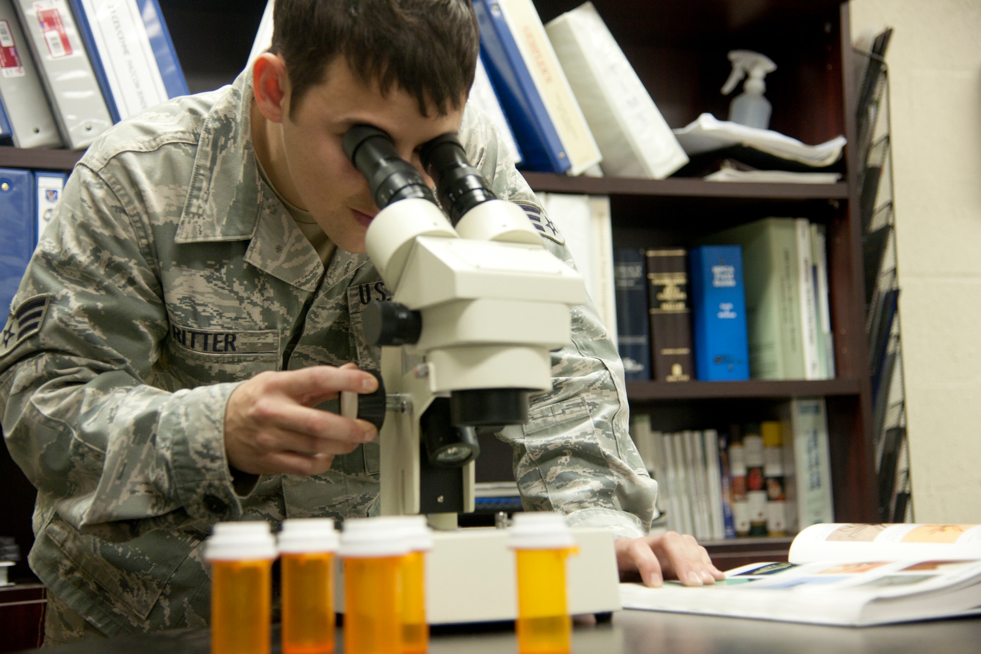 U.S. Air Force Senior Airman Travis Ritter, 23d Civil Engineer Squadron pest management technician, examines a specimen under microscope at Moody Air Force Base Ga., Jan. 22, 2012. Examining specimens is one aspect of Ritter’s job, he also performs inspections and conducts treatments around base. (U.S. Air Force Photo by Airmen 1st Class Paul Francis/Released
