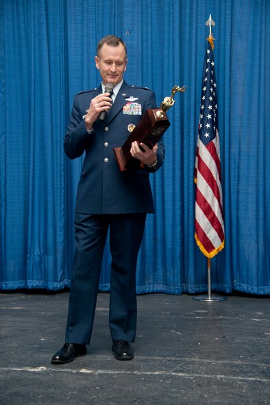 U.S. Air Force Col. Billy Thompson, 23d Wing commander, awards the Moody Spirit award during a promotion ceremony at Moody Air Force Base Ga., Jan. 31, 2012. The Moody spirit award was presented to the 23rd Security Force Squadron for being the most enthusiastic during the ceremony. (U.S. Air Force Photo by Airmen 1st Class Paul Francis/Released)
