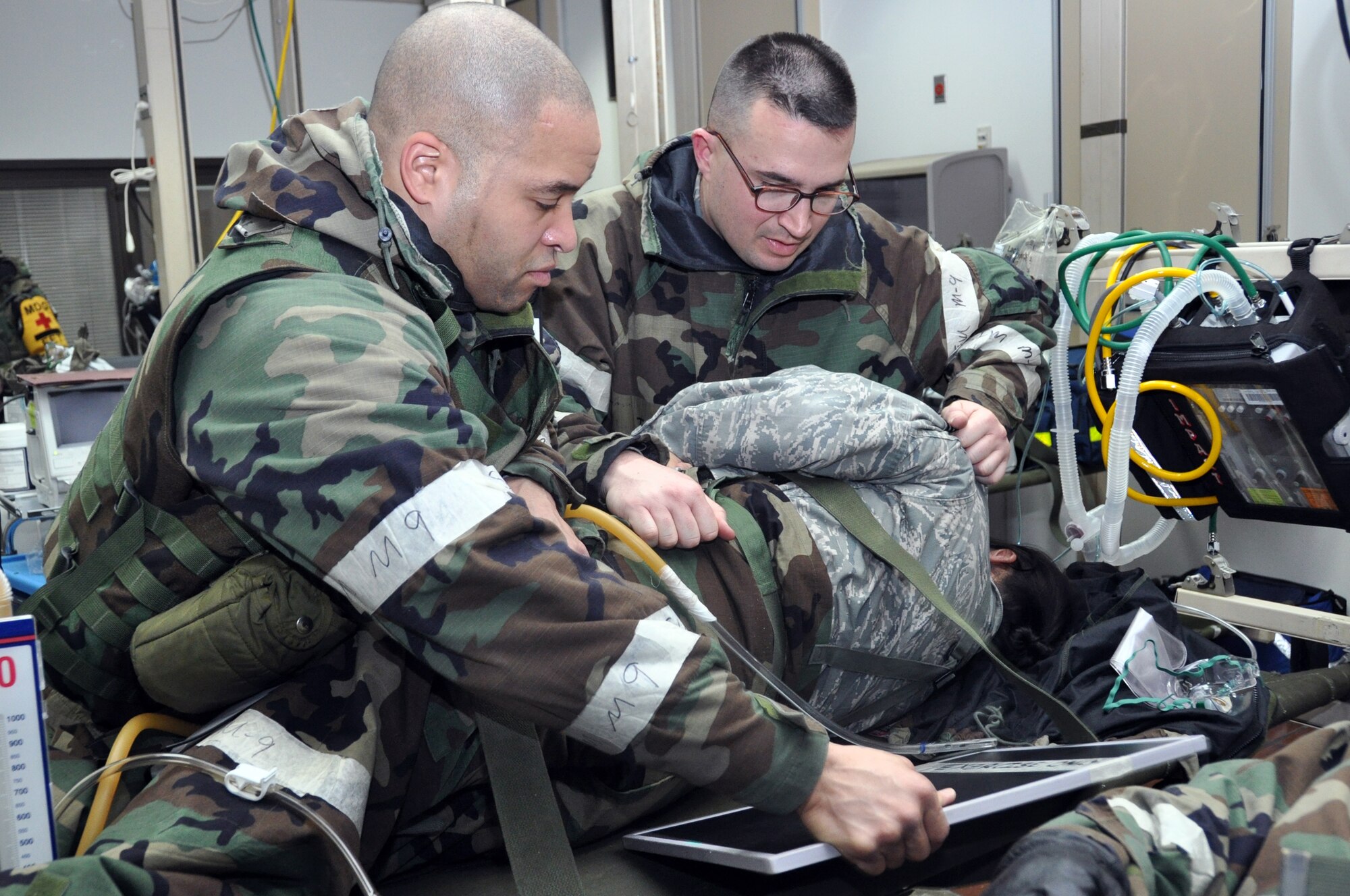 Capt. Chris Stauch, 51st Medical Group and Master Sgt. Venton Horrice, 51st Medical Operations Squadron, prepare a patient for X-ray after a simulated ground attack on the hospital Feb. 1, 2012, operational readiness exercise Beverly Bulldog 12-01at Osan Air Base, Republic of Korea. (U.S. Air Force photo/Airman 1st Class Michael Battles)