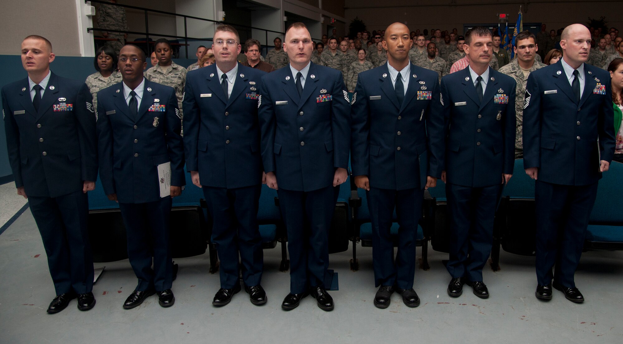 U.S. Air Force Airmen stand at attention after a promotion ceremony at Moody Air Force Base Ga., Jan. 31, 2012.  Promotees stand at attention to be recognized by fellow Airmen in attendance for earning their new rank. (U.S. Air Force Photo by Airmen 1st Class Paul Francis/Released)
