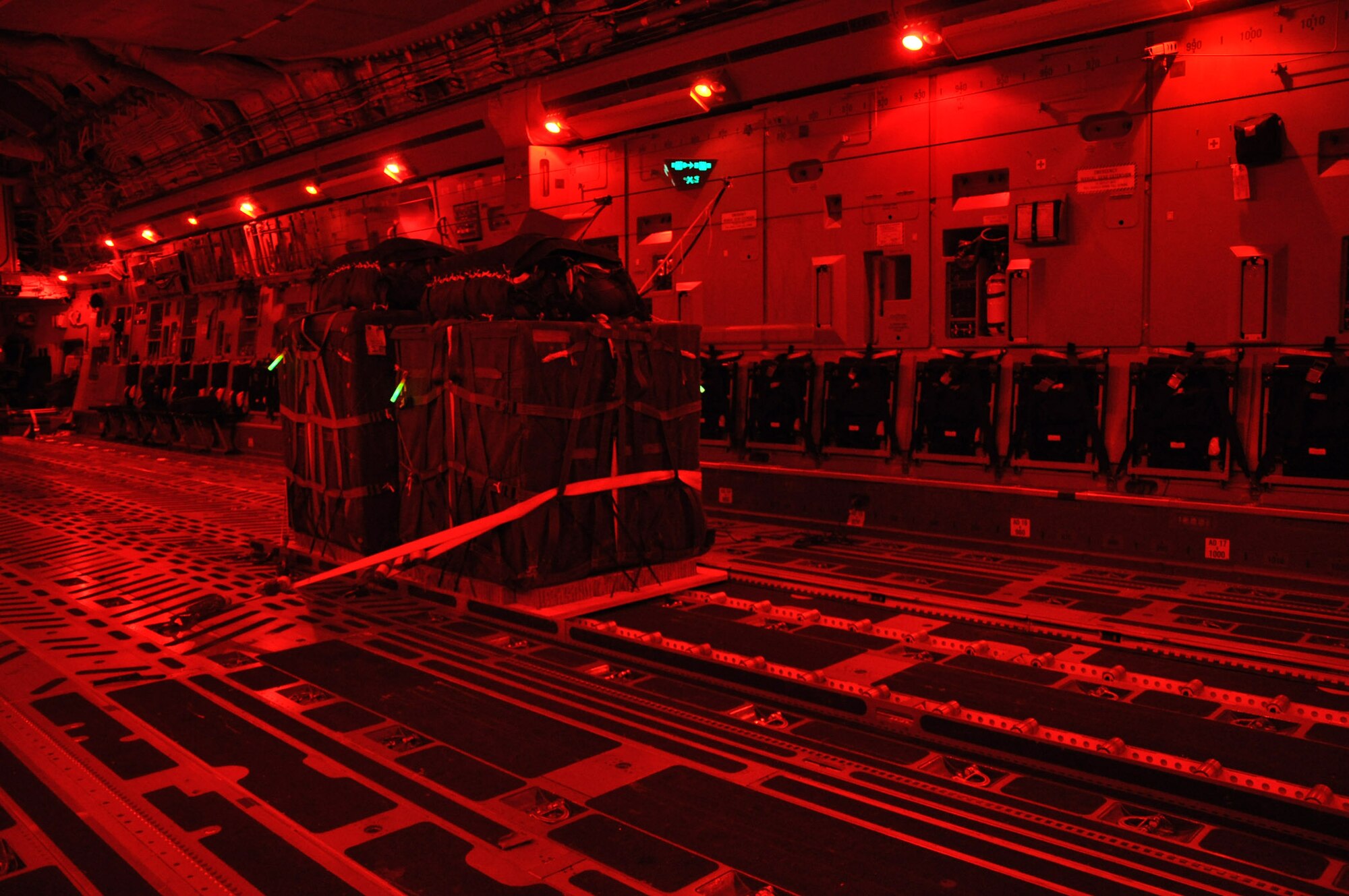 Palletized training cargo is secured aboard a C-17 Globemaster III aircraft during a night airdrop and air refueling mission January 31, 2012. (U.S. Air Force photo by Senior Airman Bobby Pilch)