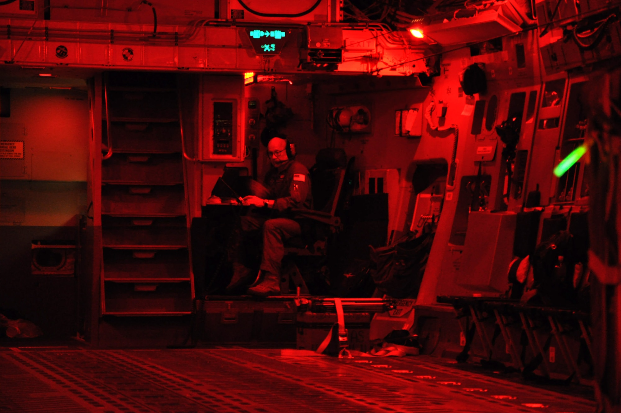 Master Sgt. Dennis Moore, a loadmaster assigned to the 701st Airlift Squadron at Joint Base Charleston, S.C. prepares final checks before releasing cargo during  a night airdrop and air refueling mission aboard a C-17 Globemaster III aircraft January 31, 2012. (U.S. Air Force photo by Senior Airman Bobby Pilch)