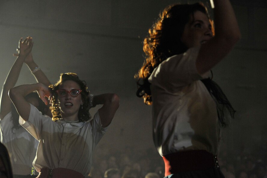 U.S. Air Force Senior Airman Petrice Brown, Senior Airman Alexandria Salinas and Airman 1st Class Aimee Grills, all Tops in Blue vocalists, pretend to be groupies during a Tops in Blue “Rhythm Nation” performance Jan. 31, 2012, Patriot Hall, Sumter, S.C. Their tour encompasses more than 70 shows worldwide and includes numerous shows for deployed service members in the Southwest Asia area of operations. (U.S. Air Force photo by Senior Airman Amber E. N. Jacobs/Released)