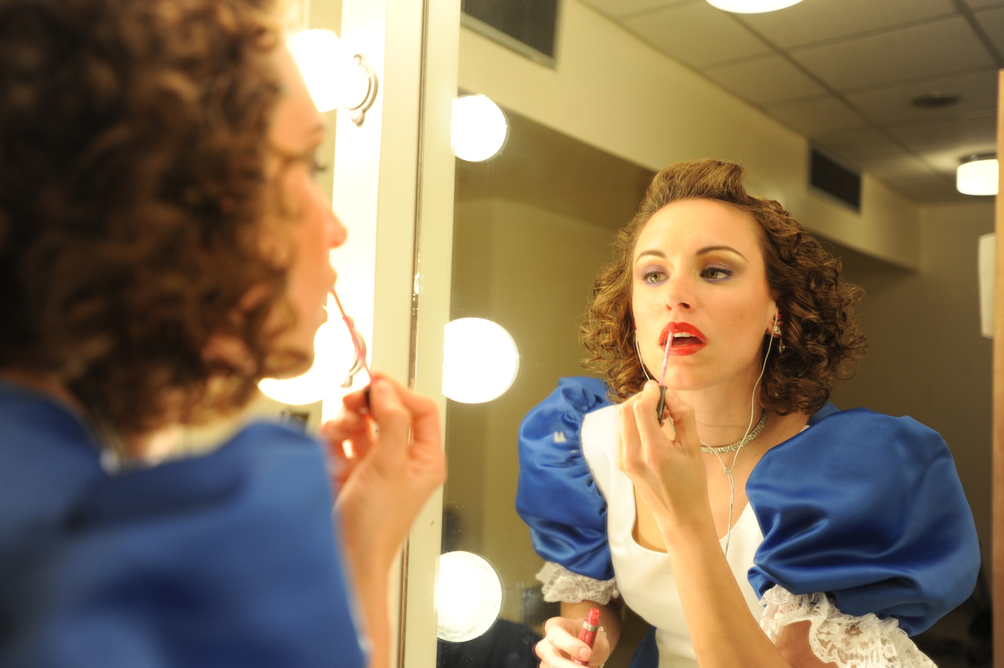 U.S. Air Force Senior Airman Alexandria, Tops in Blue vocalist, puts on makeup before a performance Jan. 31, 2012, Patriot Hall, Sumter, S.C. Their tour encompasses more than 70 shows worldwide and includes numerous shows for deployed service members in the Southwest Asia area of operations. (U.S. Air Force photo by Airman 1st Class Tabatha McCarthy/Released)