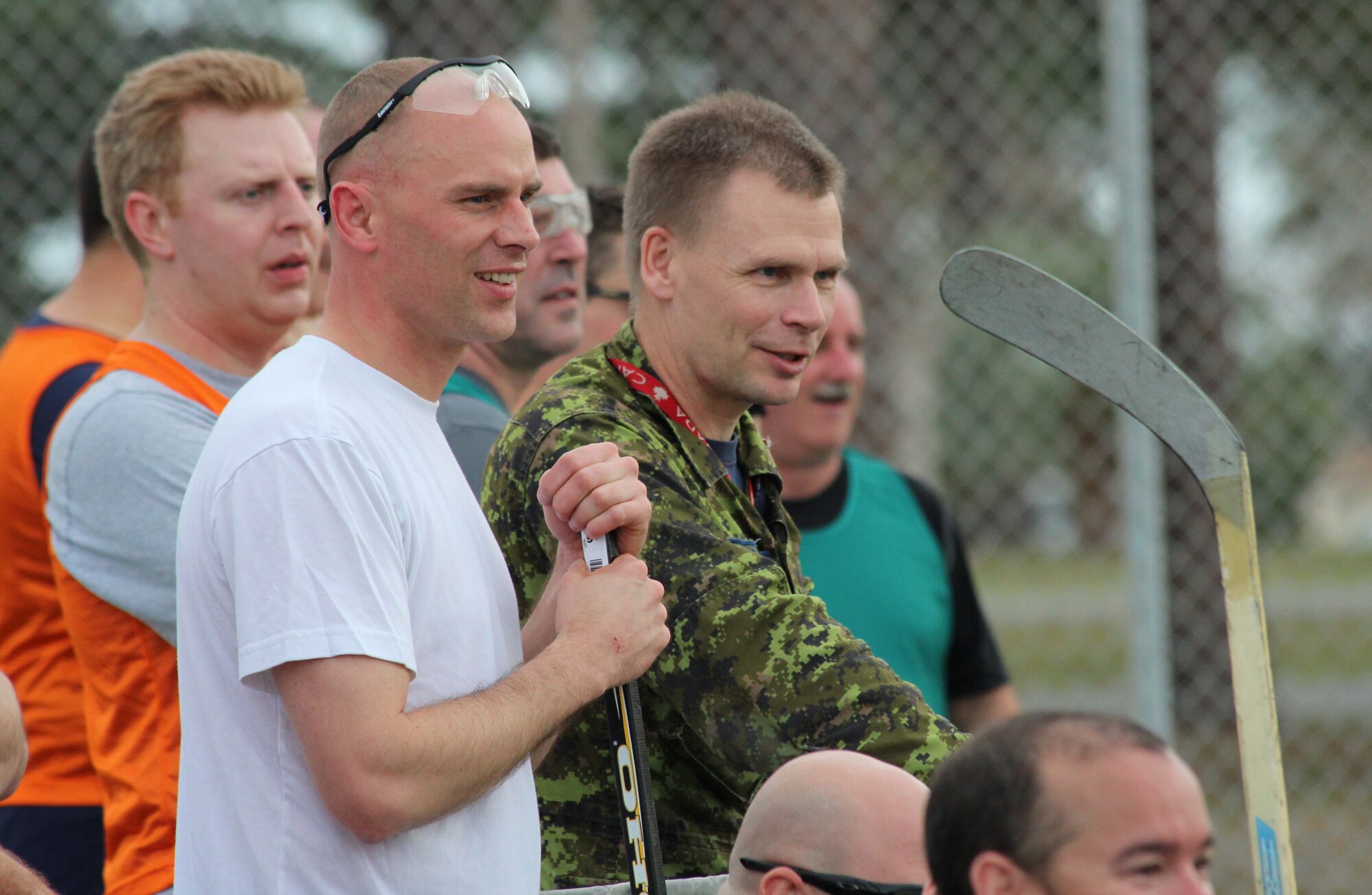 Brig. Gen. Christopher Coates (in uniform), Continental U.S. North American Aerospace Defense Command Region deputy commander, watches the action during a street hockey game between teams from the Tyndall Air Force Base Canadian Detachment and the Royal Canadian Air Force’s 409 Squadron team Jan. 31. The 409 Squadron, which flies CF-18s, is at Tyndall to participate in Combat Archer training with the 53rd Weapons Evaluation Group. Given the rarity of visits by other Canadian units to Tyndall, the base detachment jumped on the chance to play a friendly game of their national sport with fellow Canadians. (U.S. Air Force photo by Angela Pope) 