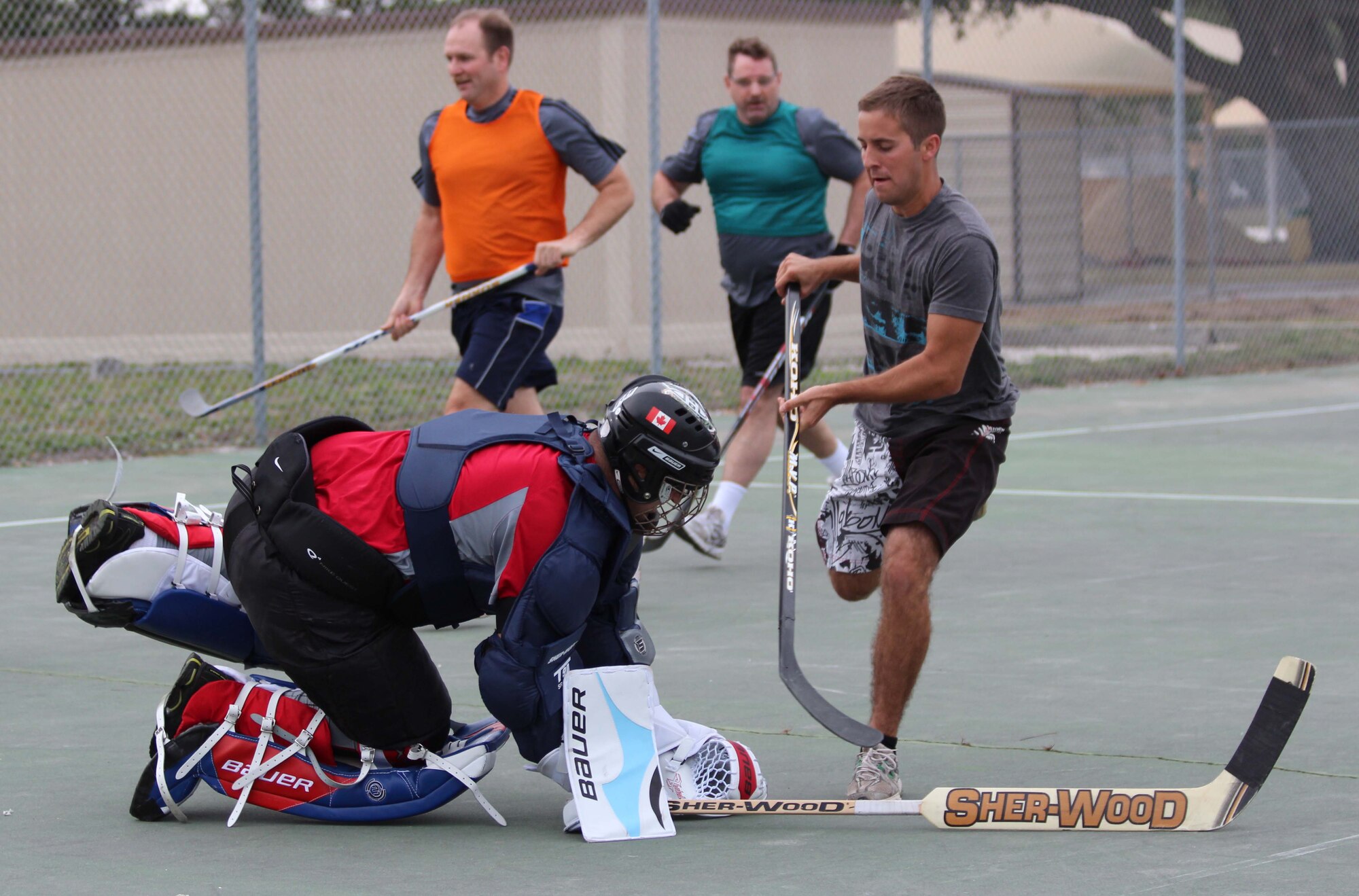 Martin Mailloux, goalie for the Tyndall Air Force Base Canadian Detachment team, blocks a shot by a member of the Royal Canadian Air Force’s 409 Squadron team during a game of street hockey Jan. 31. The 409 Squadron, which flies CF-18s, is at Tyndall to participate in Combat Archer training with the 53rd Weapons Evaluation Group. Given the rarity of visits by other Canadian units to Tyndall, the base detachment jumped on the chance to play a friendly game of their national sport with fellow Canadians. (U.S. Air Force photo by Angela Pope) 