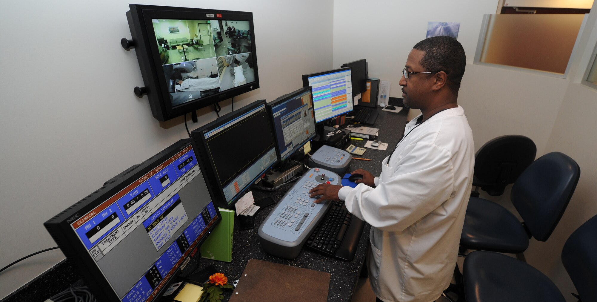 Radiation therapist Rudie Collins operates and monitors patient's at the treatment area console, Jan. 31. (U.S. Air Force photo/ Staff Sgt. Liliana Moreno)