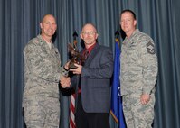 The fourth-quarter Joint Base San Antonio-Randolph award winners were recognized during an awards ceremony at the base theater Jan. 31.  Brig. Gen. Tim Zadalis, Air Education and Training Command director of intelligence, operations and nuclear integration, on left, and Chief Master Sgt. Charles Meyer, AETC chief of safety, right, present the Supervisor Civilian Category II of the Quarter Award to Paul Hughes from AETC.  (U.S. Air Force photo/Melissa Peterson)