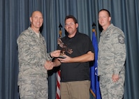 The fourth-quarter Joint Base San Antonio-Randolph award winners were recognized during an awards ceremony at the base theater Jan. 31.  Brig. Gen. Tim Zadalis, Air Education and Training Command director of intelligence, operations and nuclear integration, on left, and Chief Master Sgt. Charles Meyer, AETC chief of safety, right, present the Supervisor Civilian Category I of the Quarter Award to Darryl Sharkey from the 359th Medical Group.  (U.S. Air Force photo/Melissa Peterson)