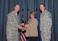 The fourth-quarter Joint Base San Antonio-Randolph award winners were recognized during an awards ceremony at the base theater Jan. 31.  Brig. Gen. Tim Zadalis, Air Education and Training Command director of intelligence, operations and nuclear integration, on left, and Chief Master Sgt. Charles Meyer, AETC chief of safety, right, present the Non-Supervisor Civilian Category I of the Quarter Award to Jennifer Deason from the Air Force Personnel Center.  (U.S. Air Force photo/Melissa Peterson)