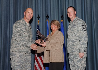 The fourth-quarter Joint Base San Antonio-Randolph award winners were recognized during an awards ceremony at the base theater Jan. 31.  Brig. Gen. Tim Zadalis, Air Education and Training Command director of intelligence, operations and nuclear integration, on left, and Chief Master Sgt. Charles Meyer, AETC chief of safety, right, present the Non-Supervisor Civilian Category I of the Quarter Award to Jennifer Deason from the Air Force Personnel Center.  (U.S. Air Force photo/Melissa Peterson)