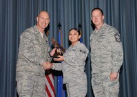 The fourth-quarter Joint Base San Antonio-Randolph award winners were recognized during an awards ceremony at the base theater Jan. 31.  Brig. Gen. Tim Zadalis, Air Education and Training Command director of intelligence, operations and nuclear integration, on left, and Chief Master Sgt. Charles Meyer, AETC chief of safety, right, present the Honor Guard Airman of the Quarter Award to Senior Airman Alissa Corallo from the Air Force Personnel Center.  (U.S. Air Force photo/Melissa Peterson)