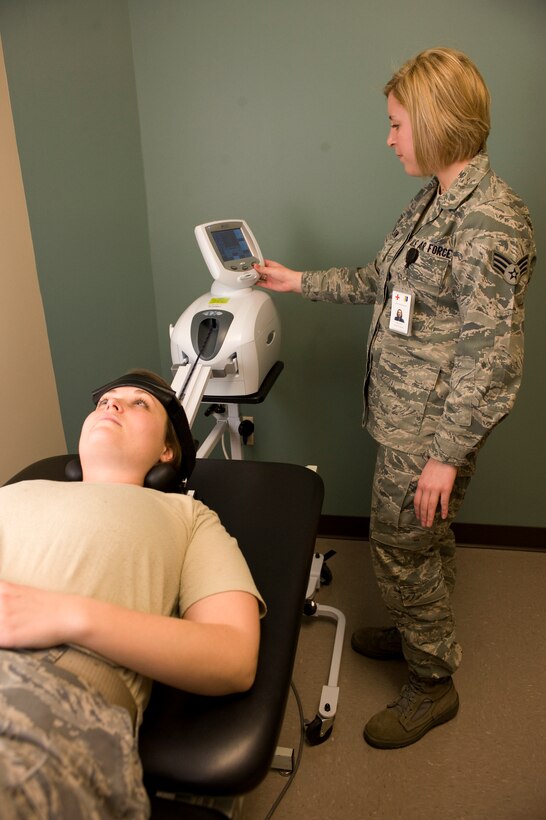 Senior Airman Haylley Carlson, 28th Medical Operations Squadron physical therapy technician, operates the cervical traction machine on Staff Sgt. Janet Schreiber, 28th Maintenance Squardon aircraft structural maintainer, at the physical therapy center on Ellsworth Air Force Base, S.D., Jan. 26, 2012.  The cervical traction treatment is designed to be painless and ranges in duration depending on patient’s injuries.  (U.S. Air Force photo by Airman 1st Class Anania Tekurio/Released)