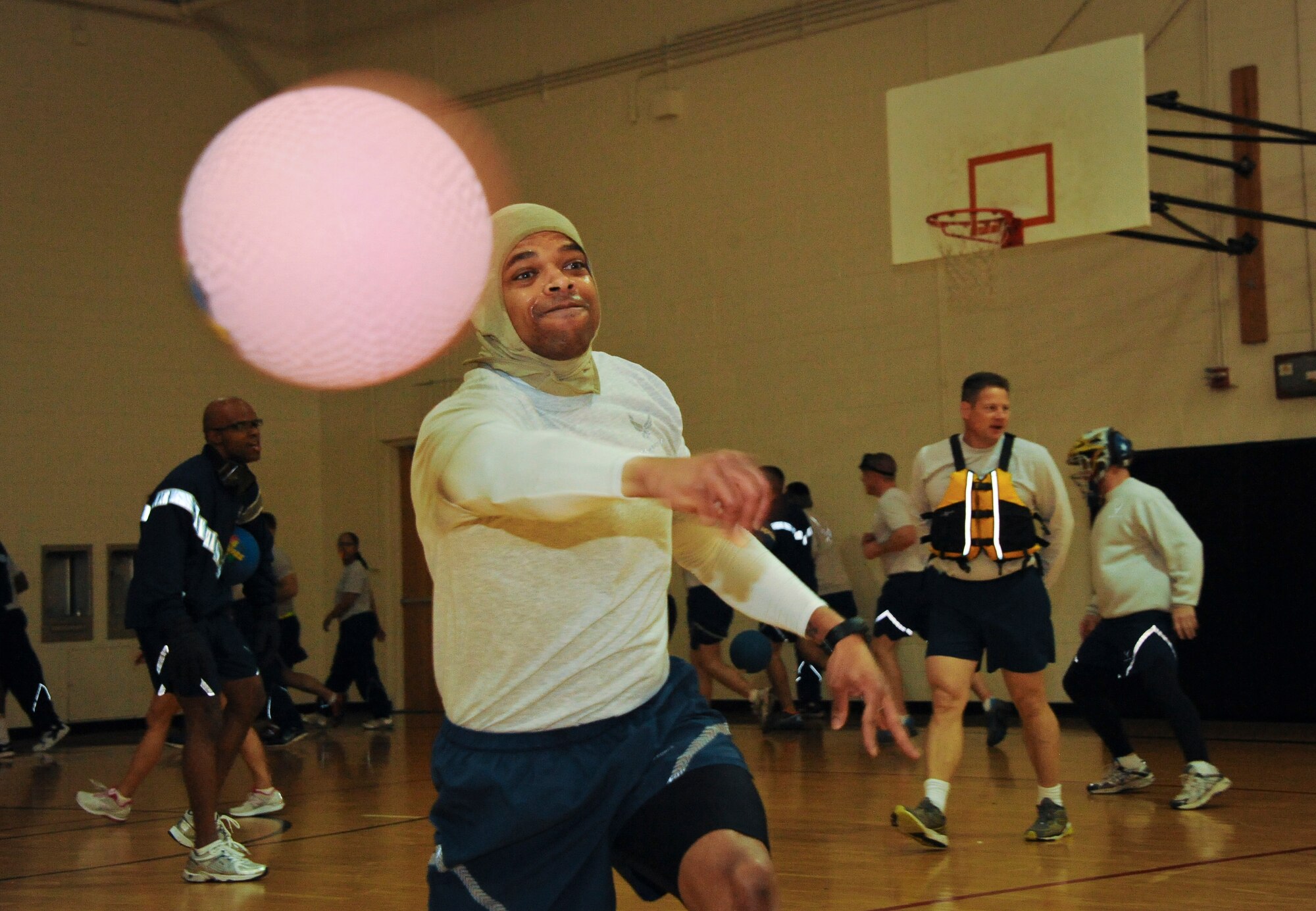 Master Sgt. Reginald Newton, a native of Jacksonville Fla. And 87th Communications Squadron Operations Light Superintendent, launches a ball at the opposing team during a safety-themed dodge ball tournament. The service members wore protective sports equipment such as helmets, knee and elbow pads and life vests. Their morning of dodge ball fun was followed by safety briefings regarding on-and off-duty mishaps. (U.S. Air Force photo by Airman 1st Class Dennis Sloan/Released)