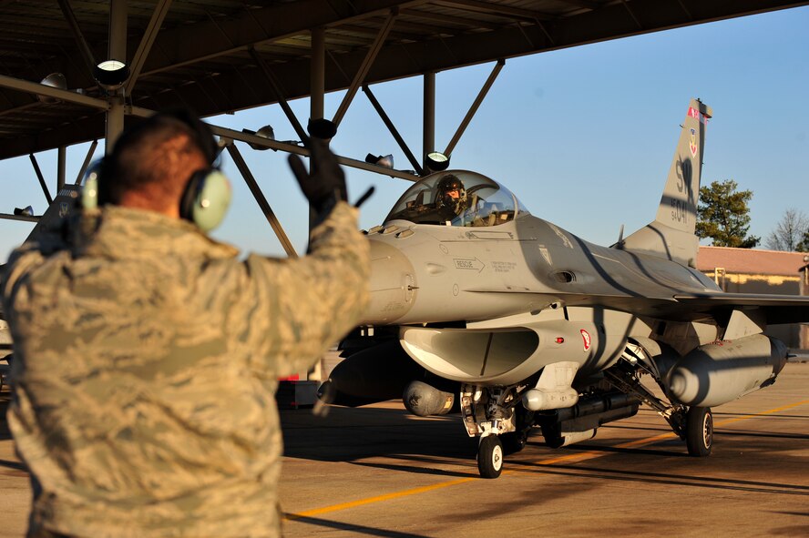 SHAW AFB - 55th Aircraft Maintenance Squadron crew chief, Airman 1st Class Matthew Andrade, a native of Winters, Calif., signals F-16 pilot, Captain Daniel Duncan, a member of the 77th Fighter Squadron, as he initiates start-up procedures during their Operational Readiness Exercise at Shaw AFB, SC on Jan. 31, 2012.    (U.S.  Air Force photo/Master Sgt. Cohen A. Young)
