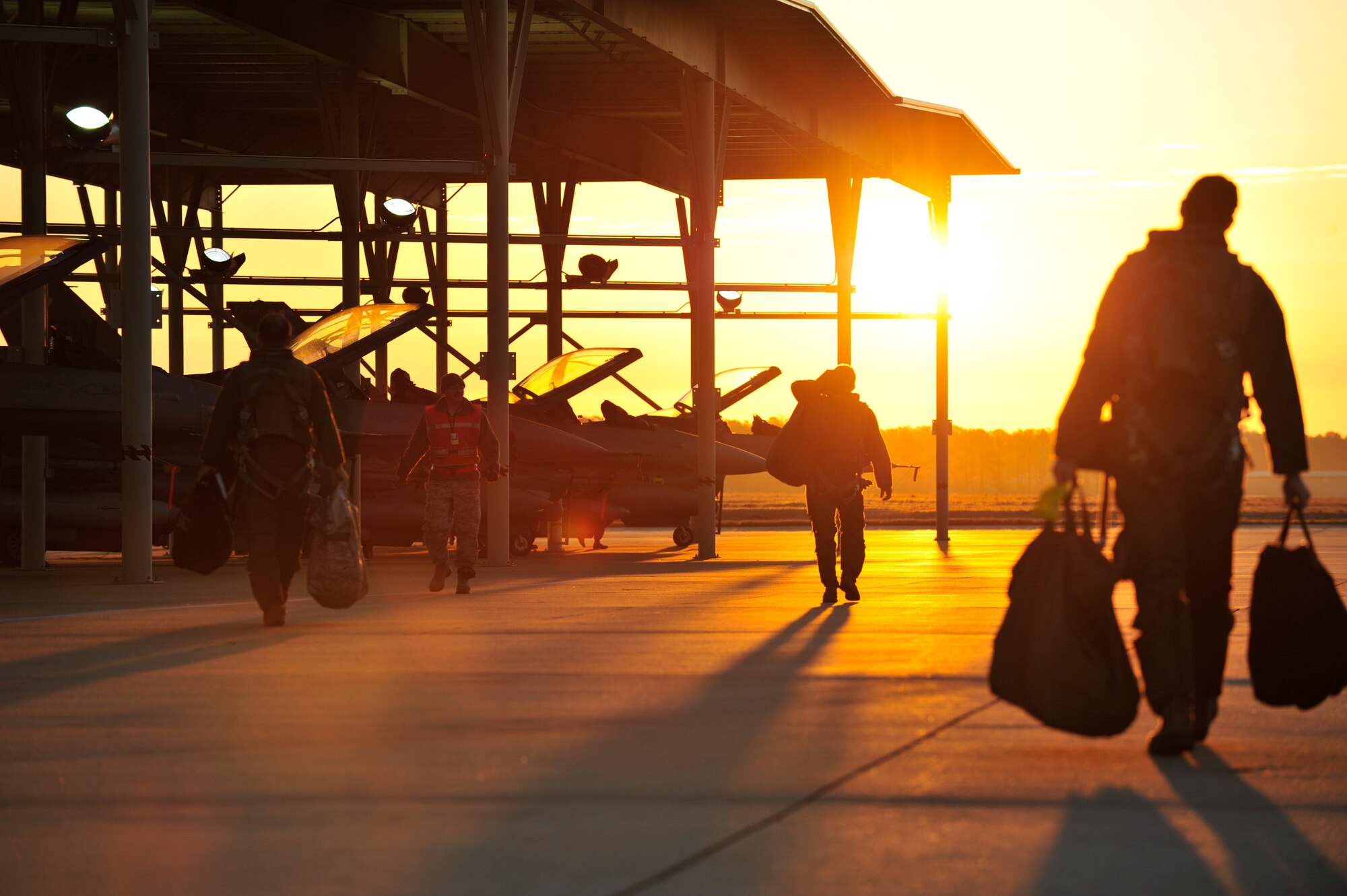 SHAW AFB - F-16 pilots from the 77th Fighter Squadron walk off to their jets to initiate start-up procedures during an Operational Readiness Exercise at Shaw AFB, SC on Jan. 31, 2012.    (U.S.  Air Force photo/Master Sgt. Cohen A. Young)