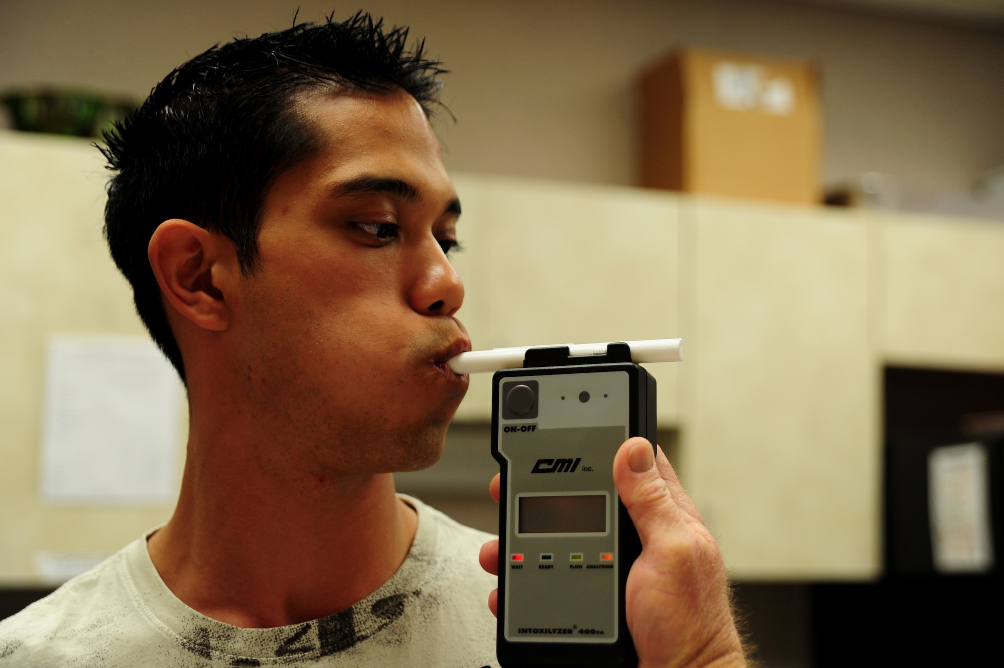 Petty Officer 2nd Class Bradley Nguyen blows into a breathalyzer so an instructor can get his blood alcohol content percentage during the Standardized Field Sobriety testing course at Joint Base Charleston – Air Base, Jan. 23-26.  628th Security Forces Squadron personnel participated in the 32- hour course which is designed to train and certify law enforcement officials in the use of driving under the influence detection techniques and national standardized field sobriety tests. Nguyen is a Master-at-Arms assigned to the 628th SFS. (U.S. Air Force photo/ Staff Sgt. Nicole Mickle)  

