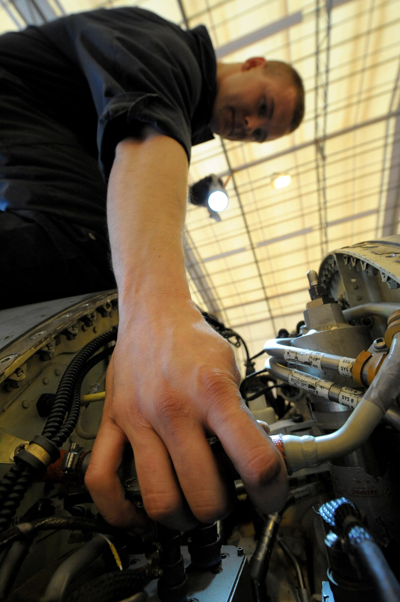 Staff Sgt. James Nunn, 332nd Expeditionary Maintenance Squadron crew chief, inspects a power drive unit bay during a phase inspection on an F-16 Fighting Falcon at an undisclosed location in Southwest Asia, Jan. 31, 2012. The power drive unit is used to control flaps on the aircraft. Nunn is deployed from Shaw Air Force Base, S.C. and is a native of Wilmington, N.C. (U.S. Air Force photo by Staff Sgt. Joshua J. Garcia/Released)