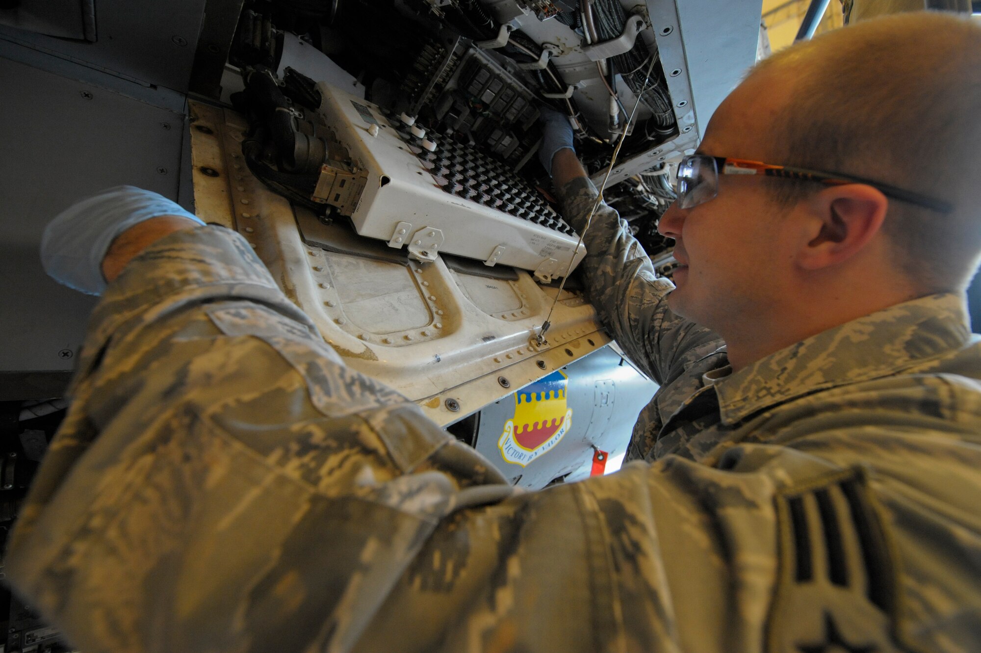 Senior Airman Larry Thames, 332nd Expeditionary Maintenance Squadron structural maintainer, replaces a nut plate cover during a phase inspection on an F-16 Fighting Falcon at an undisclosed location in Southwest Asia, Jan. 31, 2012. During the phase inspection, multiple maintenance shops work together to ensure the aircraft is in working order. Thames is deployed from Shaw Air Force Base, S.C., and is a native of Vancouver, Wash.(U.S. Air Force photo by Staff Sgt. Joshua J. Garcia/Released)