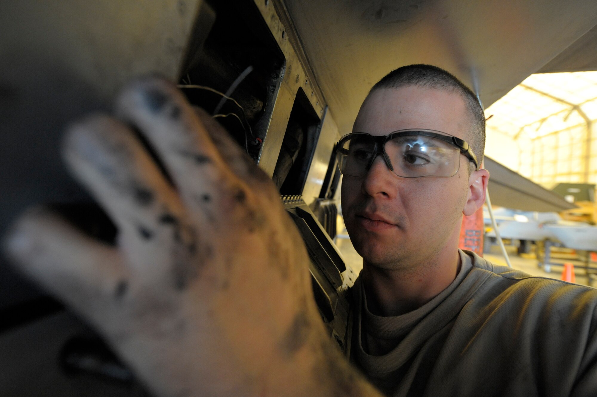 Staff Sgt. Christopher Lynch, 332nd Expeditionary Maintenance Squadron environmental/electric technician, switches out a safety wire on an F-16 Fighting Falcon during a phase inspection at an undisclosed location in Southwest Asia, Jan. 31, 2012. Aircraft enter phase after 400 flying hours for about five days. The process allows maintainers the ability to ensure every component on the aircraft is in working order. Lynch is deployed from Shaw Air Force Base, S.C., and is a native of Ft. Covington, N.Y. (U.S. Air Force photo by Staff Sgt. Joshua J. Garcia/Released)