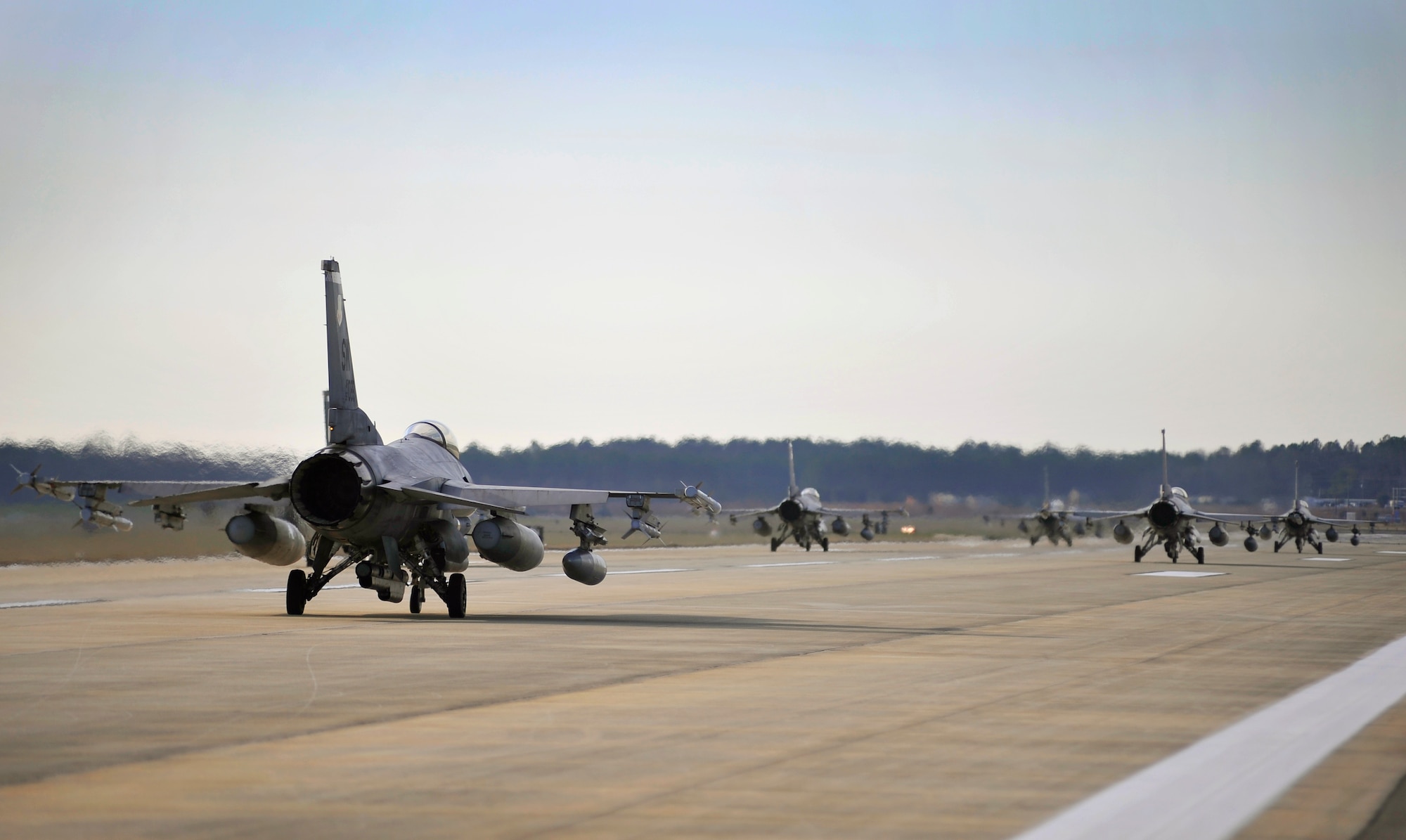 Several U.S. Air Force F-16 Fighting Falcons taxi down the Shaw runway after being prepped and launched during an Operational Readiness Exercise, Jan. 31, 2012, Shaw Air Force Base, S.C. The ORE evaluated the 20th Fighter Wing's ability to meet wartime and contingency tasks. During this particular exercise, 77th FS personnel prepped and launched several F-16s to challenge and enhance their wartime capabilities. (U.S. Air Force photo by Senior Airman Kenny Holston/Released)

