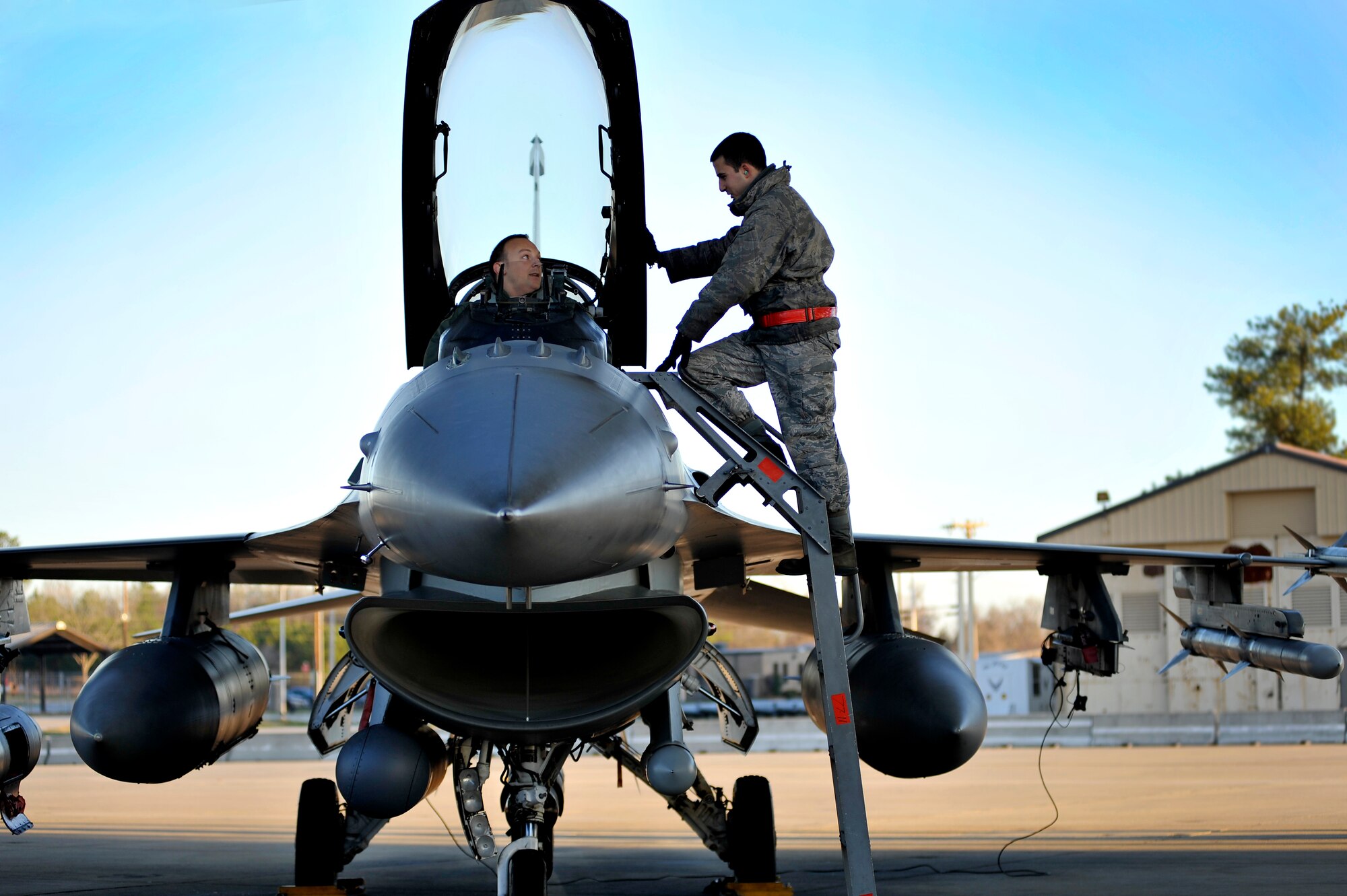 U.S. Air Force Capt. Jason Blodzinski, 77th Fighter Squadron F-16 Fighting Falcon pilot, talks with his crew chief, Senior Airman Frank Brown, 77th FS, before launching during an Operational Readiness Exercise, Jan. 31, 2012, Shaw Air Force Base, S.C. The ORE evaluated the 20th Fighter Wing's ability to meet wartime and contingency tasks. During this particular exercise, 77th FS personnel prepped and launched several F-16s to challenge and enhance their wartime capabilities. (U.S. Air Force photo by Senior Airman Kenny Holston/Released)

