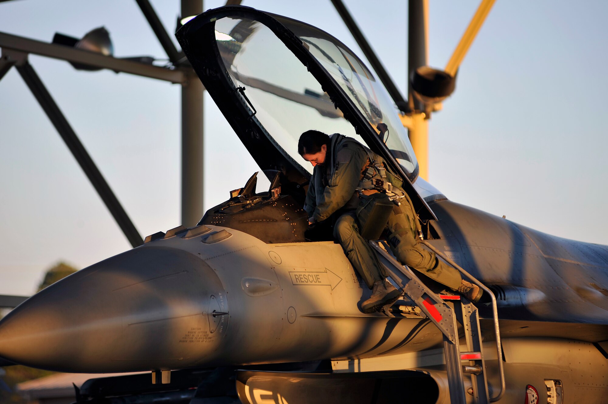 U.S. Air Force Capt. Betsy Hand, 77th Fighter Squadron F-16 Fighting Falcon pilot, situates her gear inside the cockpit of her F-16 Fighting Falcon before climbing into the aircraft, Jan. 31, 2012, Shaw Air Force Base, S.C. The ORE evaluated the 20th Fighter Wing's ability to meet wartime and contingency tasks. During this particular exercise, 77th FS personnel prepped and launched several F-16s to challenge and enhance their wartime capabilities. (U.S. Air Force photo by Senior Airman Kenny Holston/Released)

