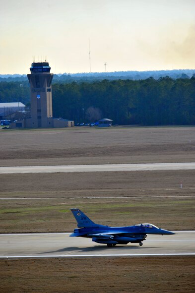 U.S. Air Force F-16 Fighting Falcon, passes the air control tower while taxiing down the flightline during an Operational Readiness Exercise at Shaw Air Force Base, S.C. Jan. 31, 2012. ORE’s train Shaw team members to be mission capable and prepare for deployments. (U.S. Air Force photo/Senior Airman Neil D. Warner/Released)