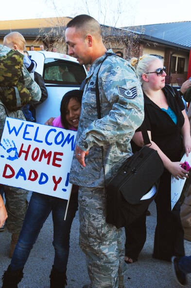 An Airman embraces his daughter after returning from a four month deployment, Jan. 30, 2012, at Dyess Air Force Base, Texas. The airmen were overseas as crew members for the first C-130J model aircraft to be deployed from Dyess. (U.S. Air Force photo by Airman 1st Class Cierra Bullock/ Released) 