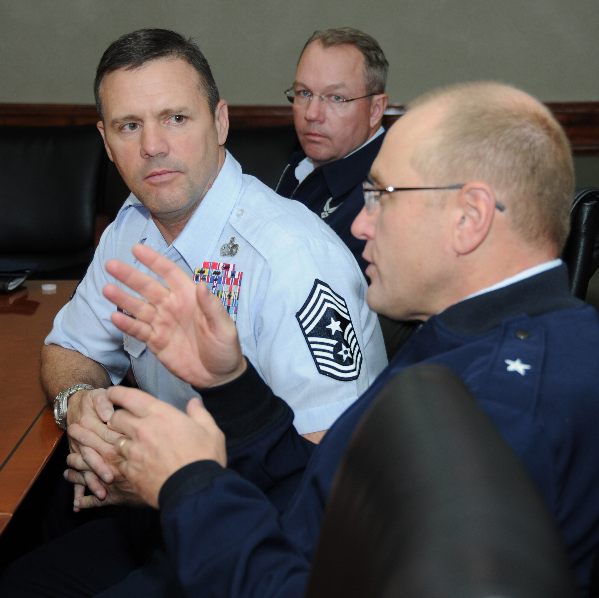 Chief Master Sgt. Oscar “Deno” Mackin, 2nd Air Force command chief, and Lt. Col. Scott Solomon, 81st Training Group deputy commander, listen as Brig. Gen. Andrew Mueller, 81st Training Wing commander, speaks during a cyber campus training network briefing Jan. 30, 2012, at Stennis Hall, Keesler Air Force Base, Miss.  Keesler is home to 2nd Air Force headquarters and the first of six bases the new command chief is scheduled to tour through June.  (U.S. Air Force photo by Kemberly Groue)