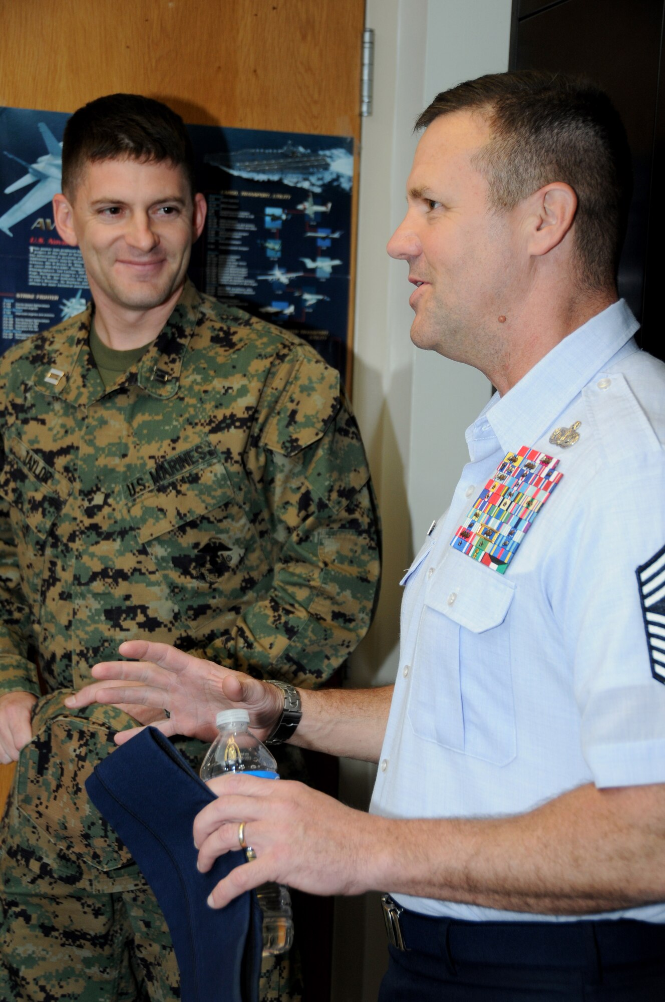 Capt. Jason Taylor, Keesler Marine Detachment, gives Chief Master Sgt. Oscar “Deno” Mackin, 2nd Air Force command chief, a tour of the Global Call Alarm Management System instructors’ office in Wolfe Hall, Keesler Air Force Base, Miss.,  Jan. 30, 2012.  Keesler is home to 2nd Air Force headquarters and the first of six bases the new command chief is scheduled to tour through June.  (U.S. Air Force photo by Kemberly Groue)