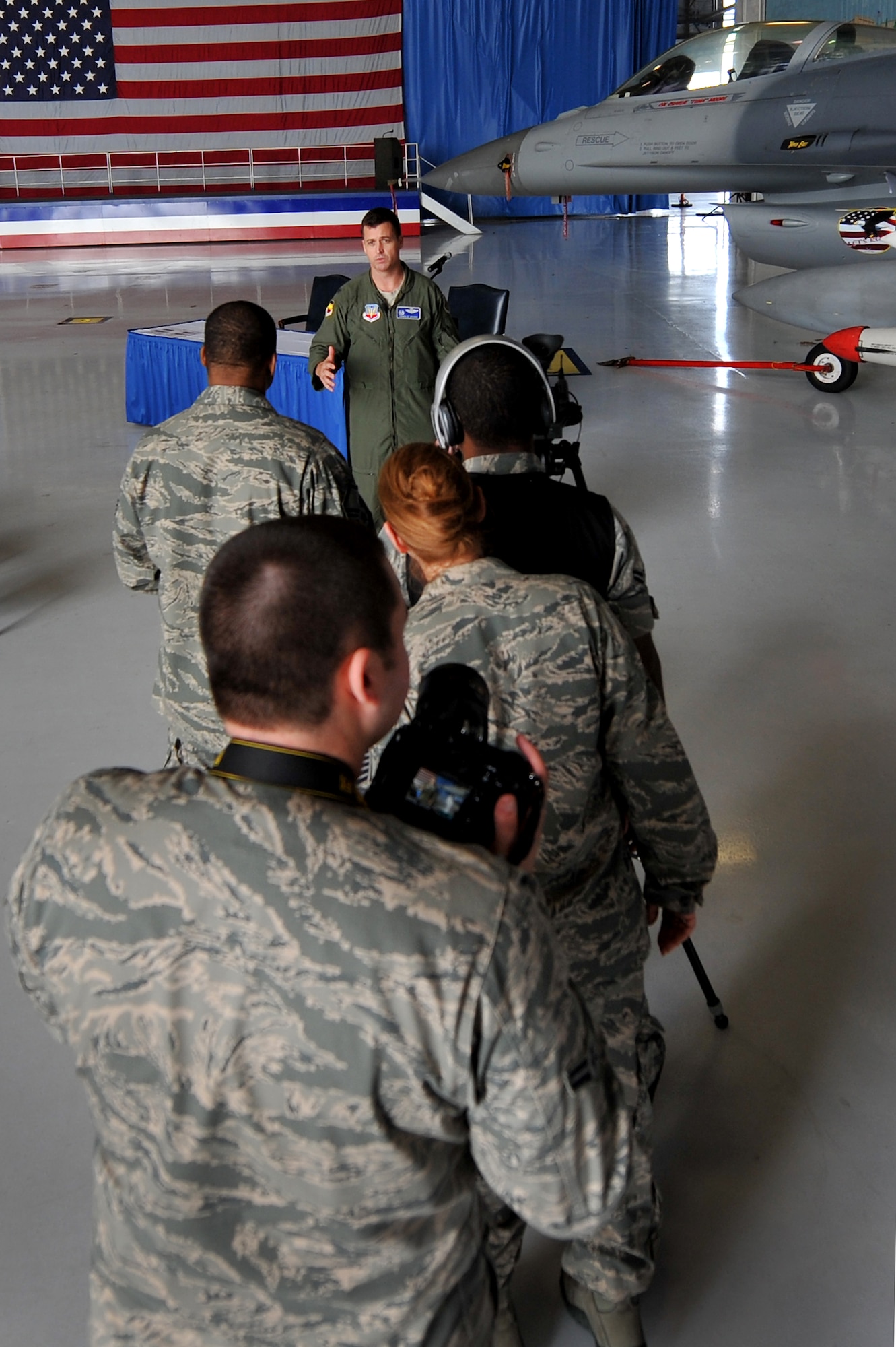 20th Fighter Wing Public Affairs journalists, broadcasters, and photojournalists line up to capture images, footage, and sound bites as Col. Charles Moore, 20th Fighter Wing commander, is interviewed about Shaw?s upcoming Air Expo, Jan. 26, 2012, Shaw Air Force Base, S.C. 20th FW/ PA personnel coordinated a press conference and provided internal media coverage of the event. Local media who attended were able to ask questions about the upcoming Shaw Air Expo take photos and interview the 20th Fighter Wing commander as well as other air expo coordinators. The Shaw Air Expo is scheduled for May 5-6, 2012. (U.S. Air Force photo by Senior Airman Kenny Holston/Released)