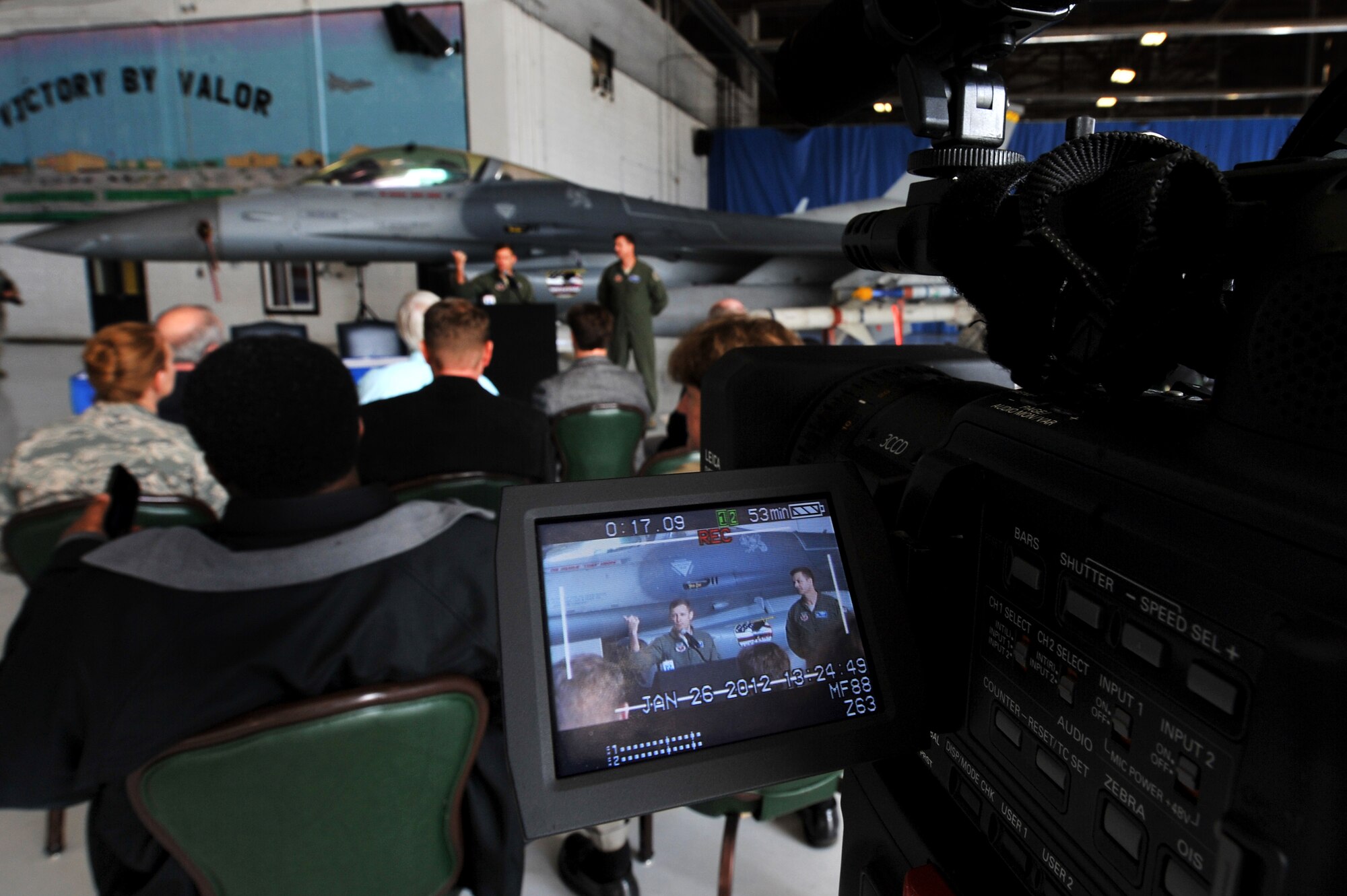 A local media agencies video camera captures footage of Lt. Col. Scott Walker, Shaw Air Expo coordinator speaking to local reporters and Sumter County officials about Shaw?s upcoming Air Expo, Jan. 26, 2012, Shaw Air Force Base, S.C. 20th FW Public Affairs personnel coordinated the conference and provided internal media coverage of the event. Local media who attended were able to ask questions about the upcoming Shaw Air Expo take photos and interview the 20th Fighter Wing commander as well as other air expo coordinators. The Shaw Air Expo is scheduled for May 5-6, 2012. (U.S. Air Force photo by Senior Airman Kenny Holston/Released) 