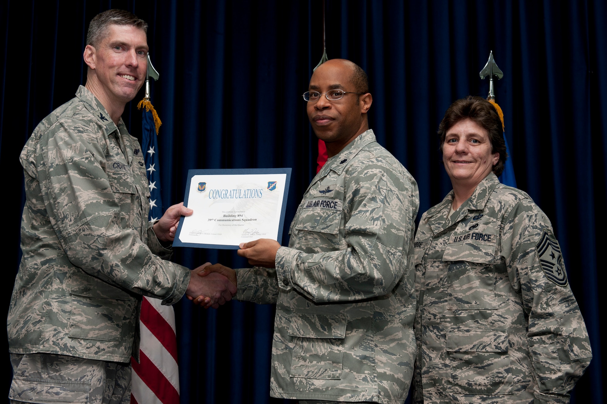 Lt. Col. Patrick Daniel, 39th Communications Squadron commander, accepts the Dormitory of the Quarter Award on behalf of the 39th CS Jan. 31, 2012, at the Club Complex ballroom at Incirlik Air Base, Turkey. (U.S. Air Force photo by Tech. Sgt. Michael B. Keller/Released)