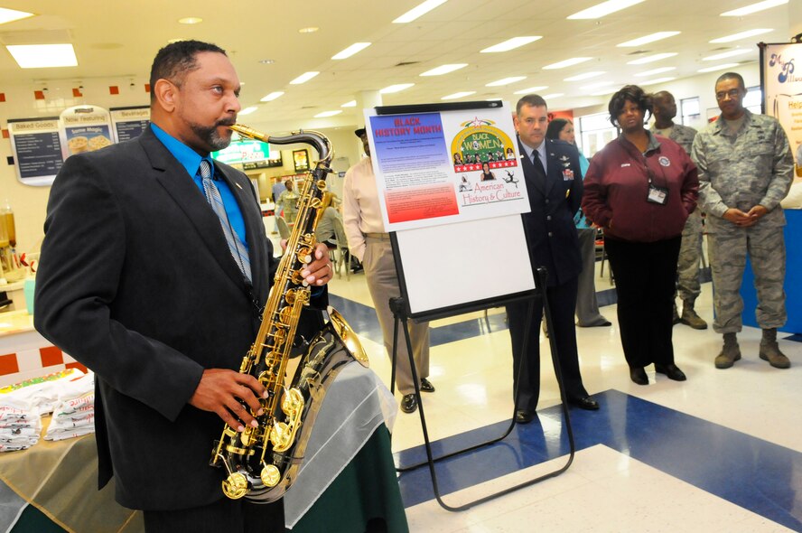 Otis Hicks, 78th CEG director, plays the Black National Anthem, "Lift Every Voice and Sing," on saxaphone during the Black Heritage Proclamation Signing Jan 31 at the BX. (U. S. Air Force photo by Sue Sapp)