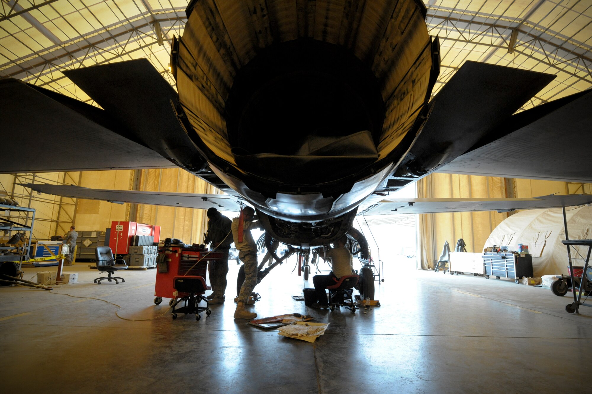 Members of the 332nd Expeditionary Maintenance Squadron, work on an F-16 Fighting Falcon during a phase inspection at an undisclosed location in Southwest Asia, Jan. 31, 2012. Aircraft go through the phase inspection every 400 flying hours to ensure they are in working order. (U.S. Air Force photo by Staff Sgt. Joshua J. Garcia/Released)