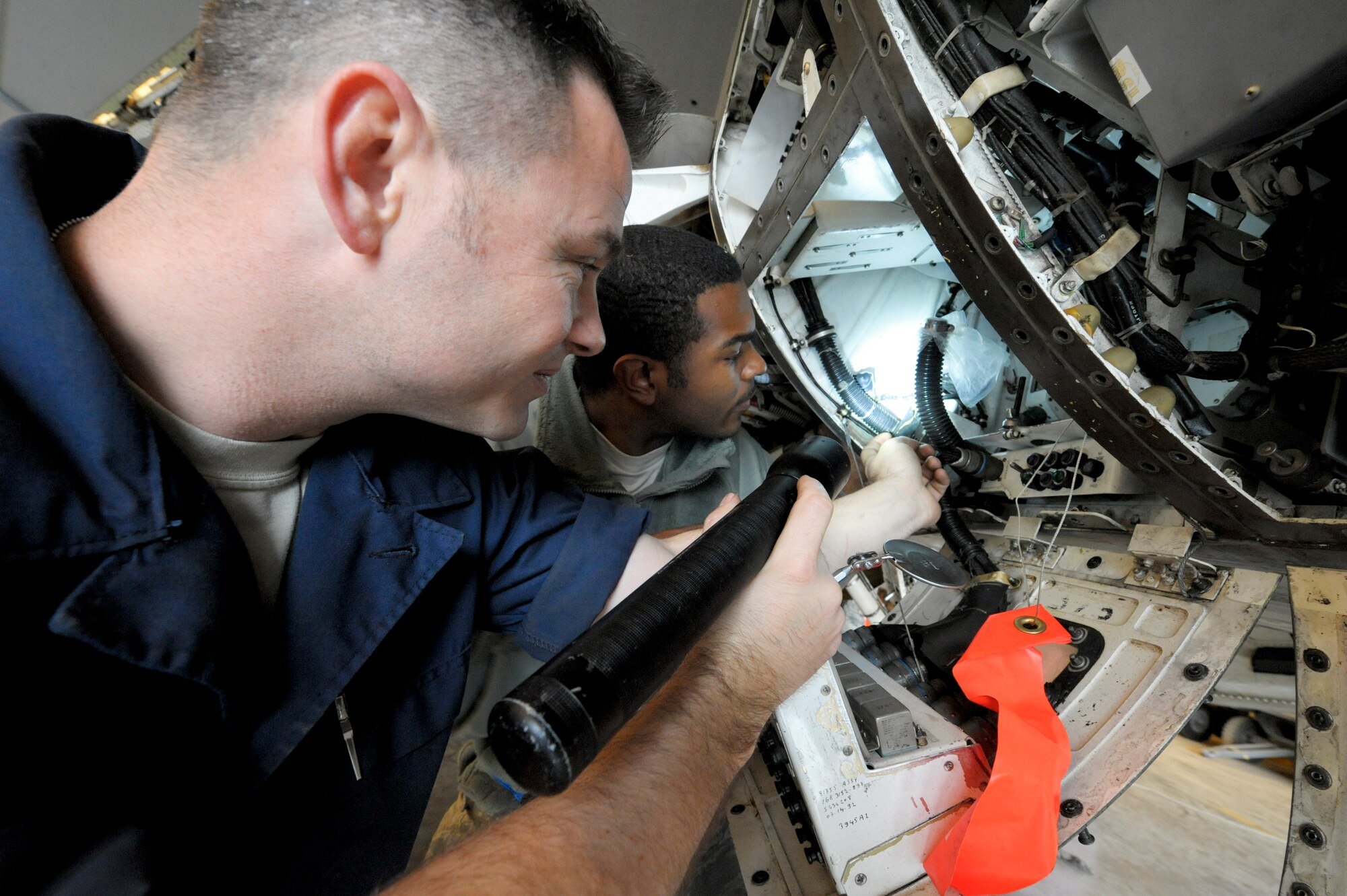 Staff Sgt. Casey Villines, 332nd Expeditionary Maintenance Squadron crew chief and Senior Airman Michael Johnson, 332nd EMXS environmental/electric technician, inspect a panel on an F-16 Fighting Falcon during a phase inspection at an undisclosed location in Southwest Asia, Jan. 31, 2012. During phase the aircraft is inspected thoroughly to ensure each component of the aircraft is properly functioning. Villines a native of Spearman, Texas, and Johnson is a native of Fayette, Miss. Both are deployed from Shaw Air Force Base, S.C.(U.S. Air Force photo by Staff Sgt. Joshua J. Garcia/Released)