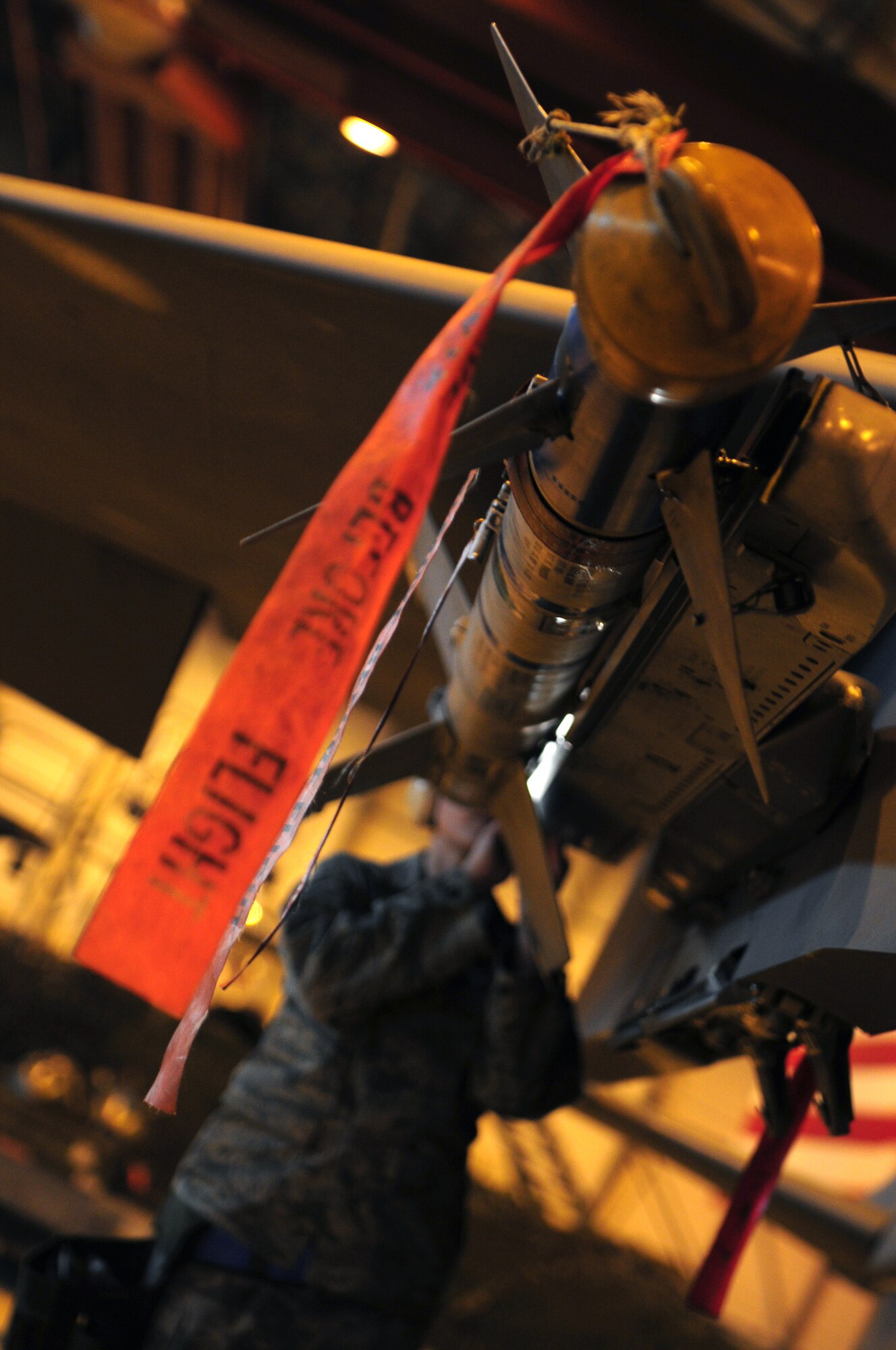 ROYAL AIR FORCE LAKENHEATH, England -- Staff Sgt. Amanda Looze, 48th Aircraft Maintenance Squadron weapons load team leader, executes final checks on weapons loaded onto an F-15E Strike Eagle during the Load Crew of the Year Competition, Jan. 27, 2012.  The yearly competition features the best load crew teams from the 492nd, 493rd and 494th Aircraft Maintenance Units. The winner is determined by the fastest time loading munitions with the least amount of errors. (U.S. Air Force photo by Airman 1st Class Cory D. Payne)