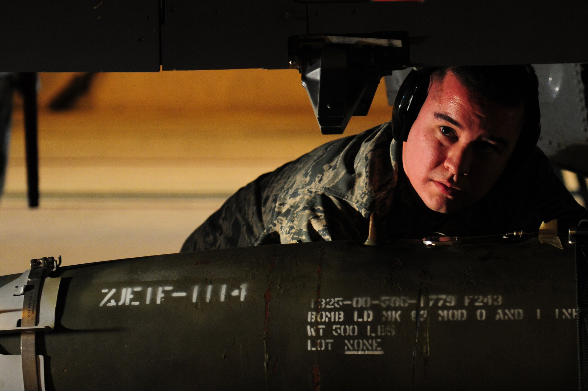 ROYAL AIR FORCE LAKENHEATH, England -- Tech. Sgt. Anthony Spencer, 48th Aircraft Maintenance Squadron weapons load team leader, loads munitions onto an F-15E Strike Eagle during the Load Crew of the Year Competition, Jan. 27, 2012.  The yearly competition features the best load crew teams from the 492nd, 493rd and 494th Aircraft Maintenance Units. The winner is determined by the fastest time loading munitions with the least amount of errors. (U.S. Air Force photo by Airman 1st Class Cory D. Payne) 
 
