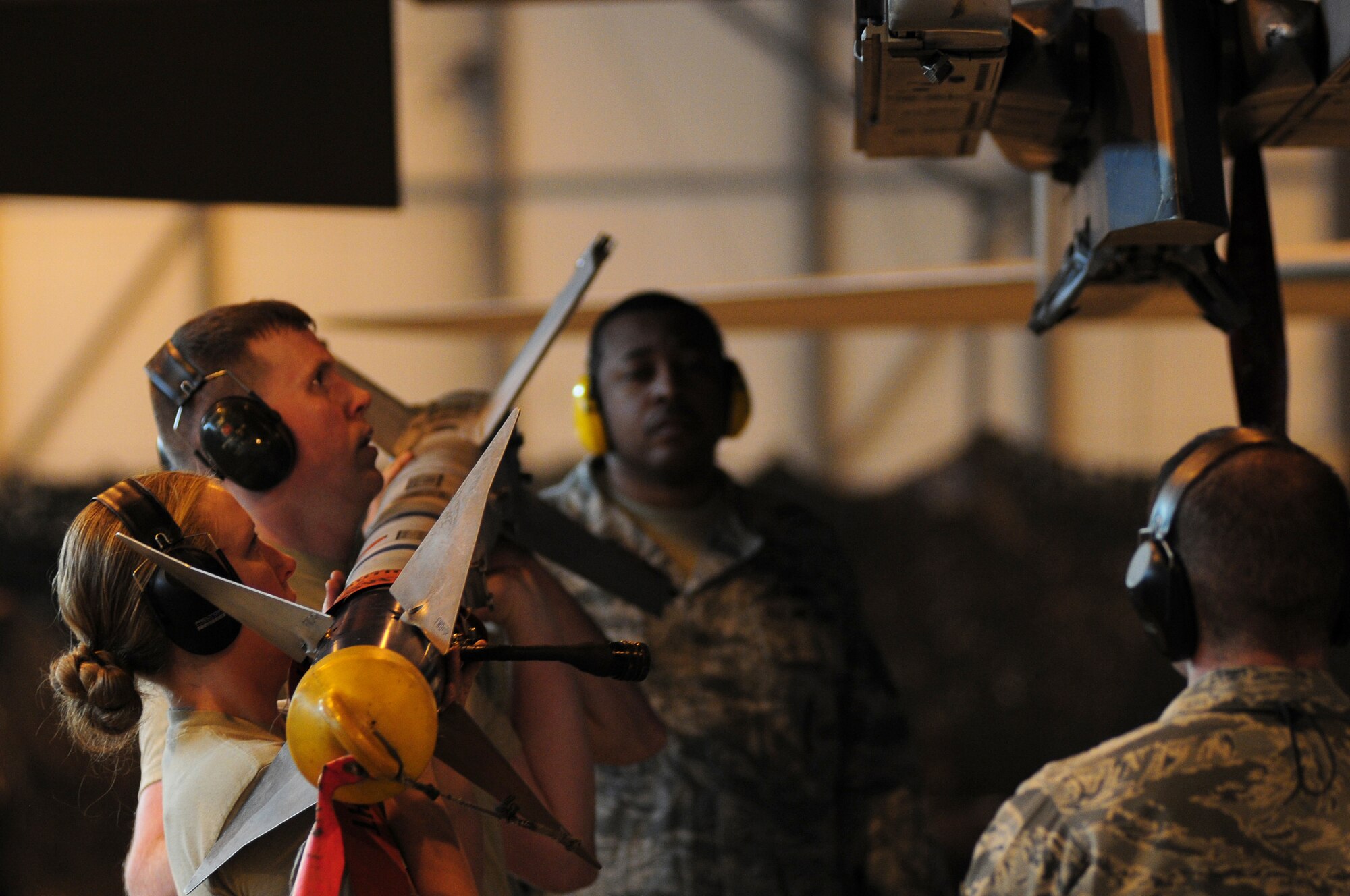 ROYAL AIR FORCE LAKENHEATH, England -- A weapons load team prepares to lift and load munitions onto an F-15E Strike Eagle during the Load Crew of the Year Competition, Jan. 27, 2012.  The yearly competition features the best load crew teams from the 492nd, 493rd and 494th Aircraft Maintenance Units. The winner is determined by the fastest time loading munitions with the least amount of errors. (U.S. Air Force photo by Airman 1st Class Cory D. Payne)