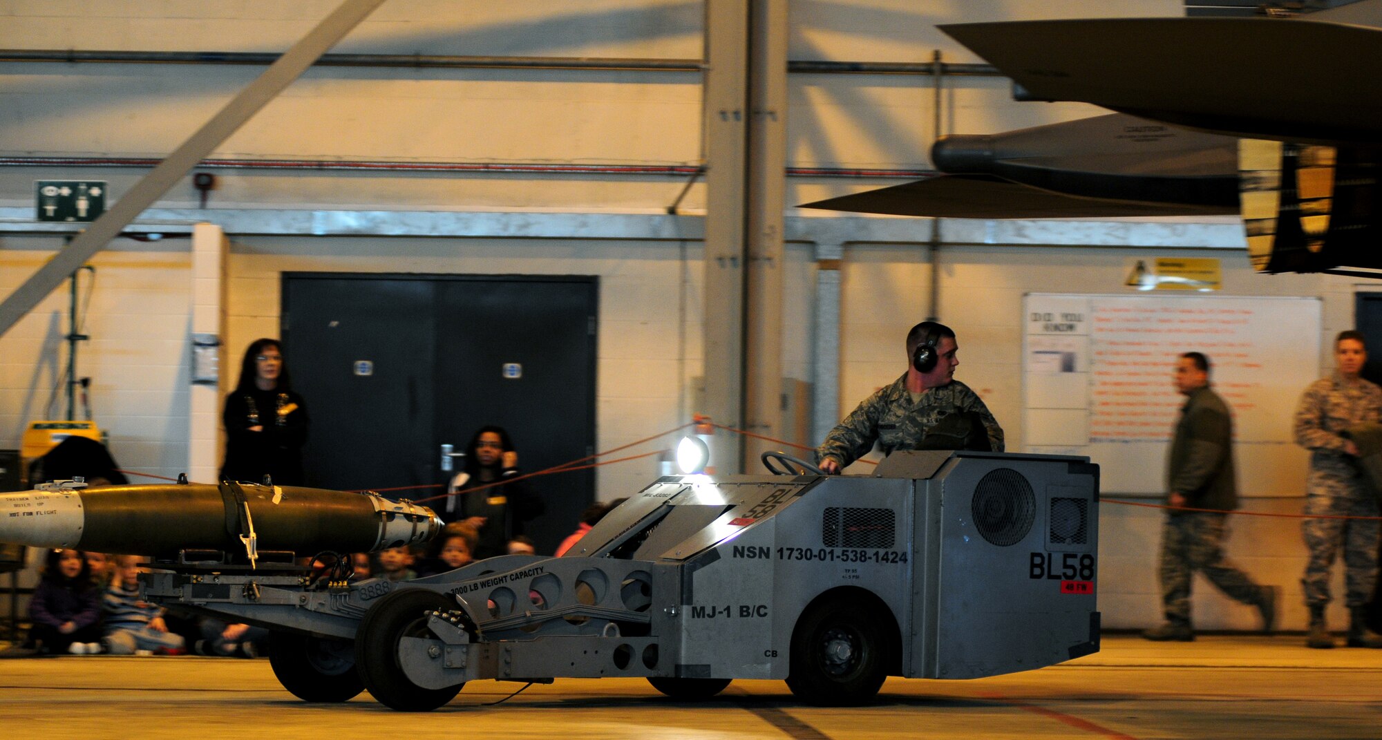 ROYAL AIR FORCE LAKENHEATH, England -- Airman 1st Class Evan Schroeder, 48th Aircraft Maintenance Squadron weapons load team member, transports munitions to load onto an F-15E Strike Eagle during the Load Crew of the Year Competition, Jan. 27, 2012.  The yearly competition features the best load crew teams from the 492nd, 493rd and 494th Aircraft Maintenance Units. The winner is determined by the fastest time loading munitions with the least amount of errors. (U.S. Air Force photo by Airman 1st Class Cory D. Payne)