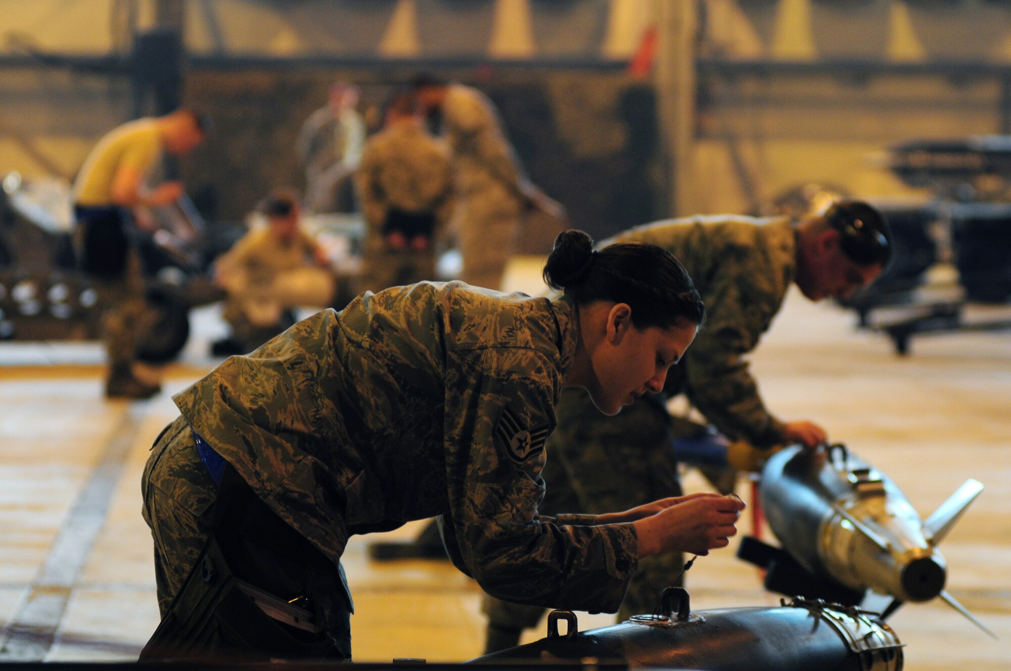 ROYAL AIR FORCE LAKENHEATH, England -- Staff Sgt. Amanda Looze, 48th Aircraft Maintenance Squadron weapons load team leader, prepares munitions for loading onto an F-15E Strike Eagle during the Load Crew of the Year Competition, Jan. 27, 2012.  The yearly competition features the best load crew teams from the 492nd, 493rd and 494th Aircraft Maintenance Units. The winner is determined by the fastest time loading munitions with the least amount of errors. (U.S. Air Force photo by Airman 1st Class Cory D. Payne)