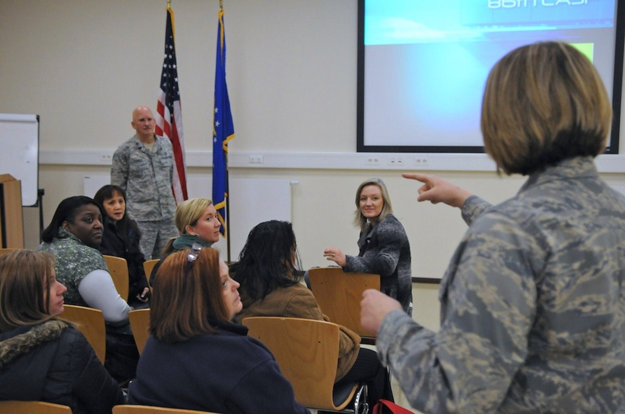 Members of the UISAFE Chiefs' Spouses Group recieve a briefing from Majors Paul Schulte (left) and Marie Coppola (right) from the Contingency Aeromedical Staging Facility January 26, 2012. The CASF is a half-way point between wounded warriors who are receiving treatmentand their return back to the states. (courtesy photo by Robert Medeiros)